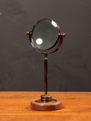 Big magnifier on wooden stand