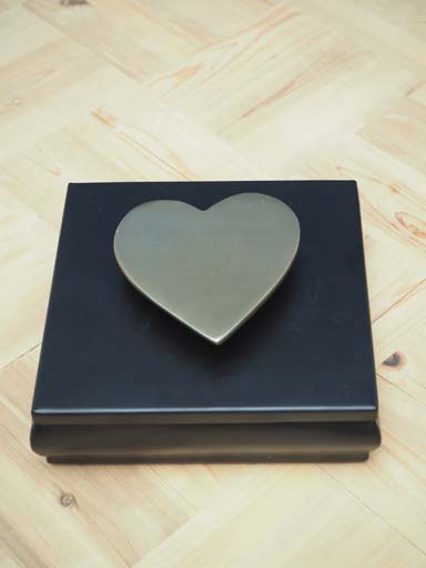 Black metal box and golden heart