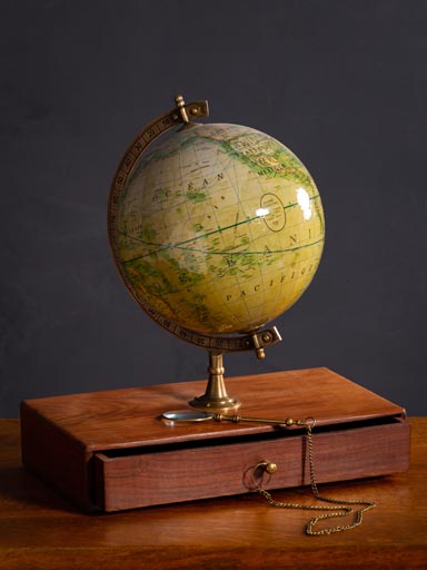 Globe with magnifier on small rack with drawer