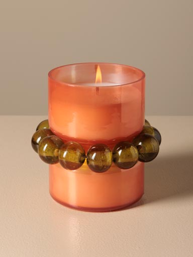 Orange candle with green bracelet