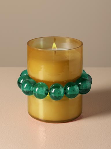 Amber candle with emerald bracelet