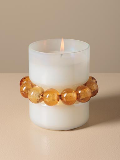 White candle with orange bracelet