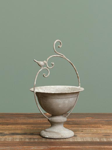Round planter on stand with bird
