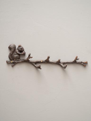Coat rack with squirrel on branch