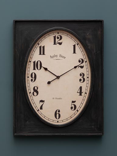 Oval clock in rectangular frame