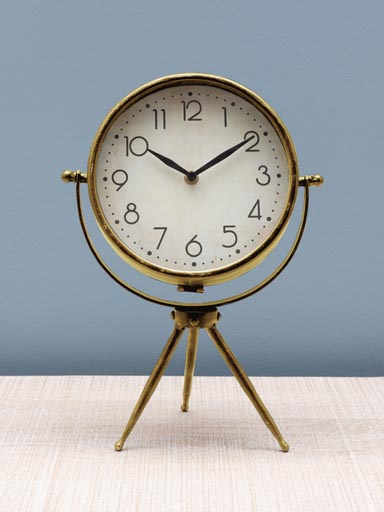 Small golden clock on tripod