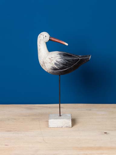 Wooden egret on log