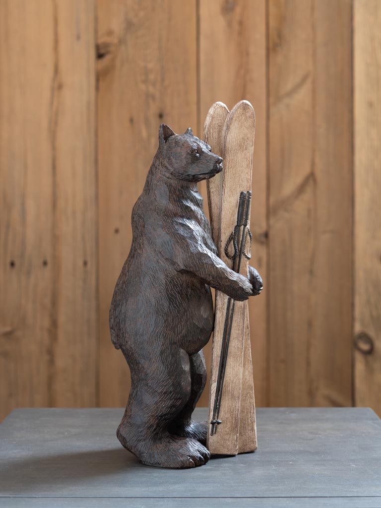 Bear holding skis - 1