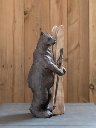 Bear holding skis