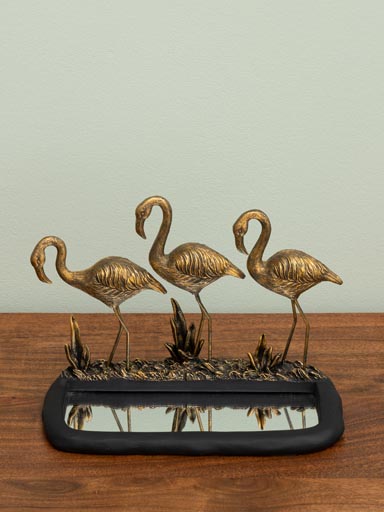 Golden flamingos with mirror pond