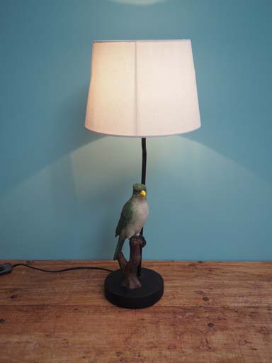 Lamp with green bird on branch with shade