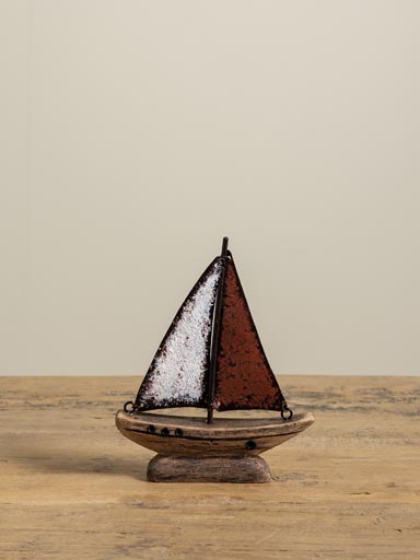 Small boat with red iron sail